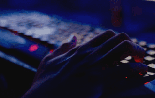 Hand on a keyboard potentially hacking