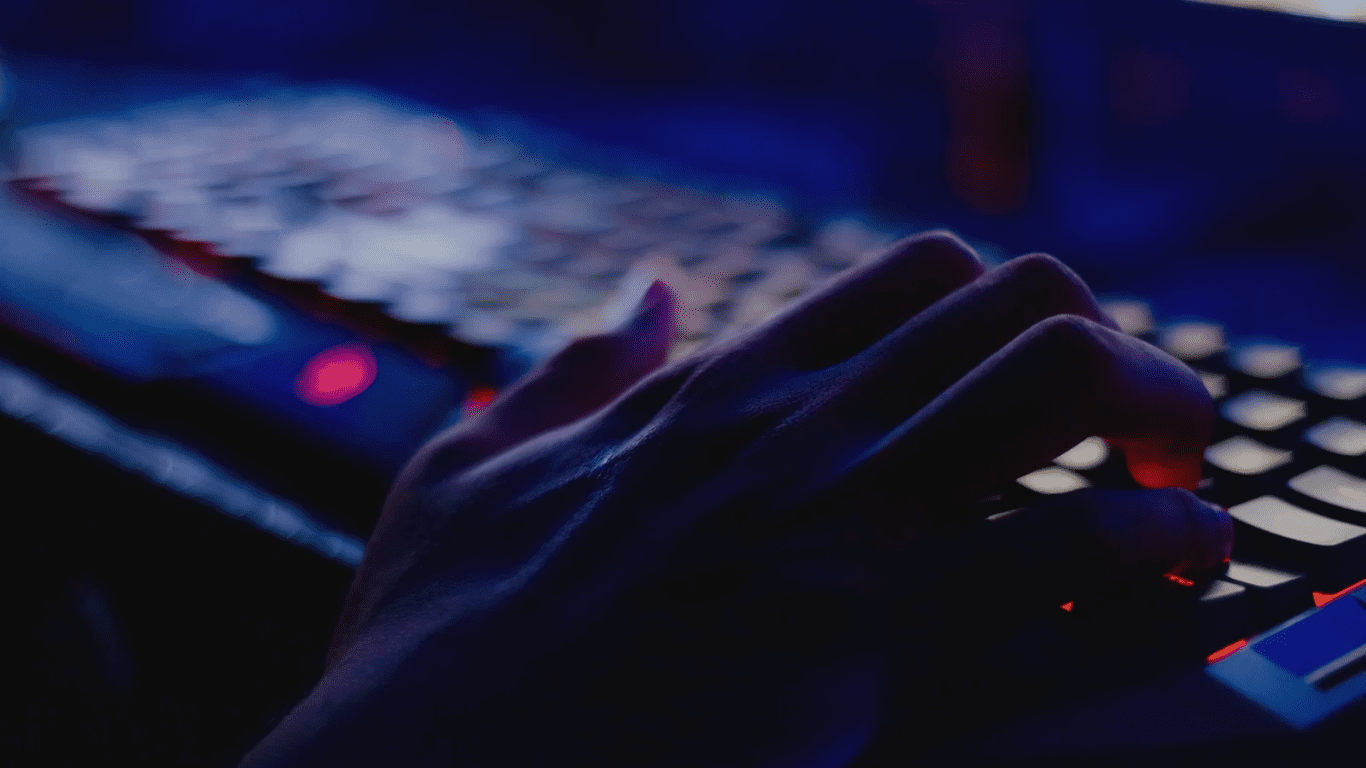 Hand on a keyboard potentially hacking